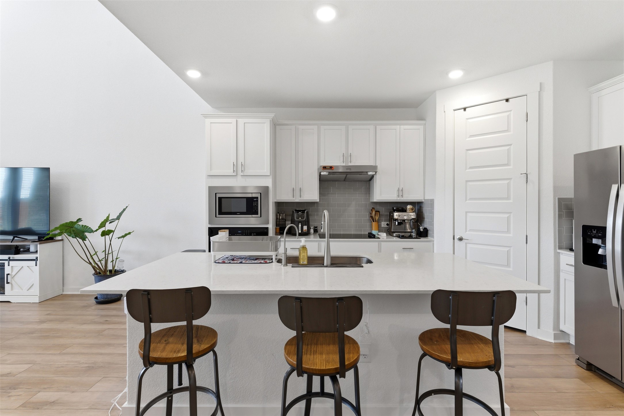 105 Nuntree Cove Georgetown, TX 78628 - Photo 6 of 31 a kitchen with stainless steel appliances a dining table chairs and refrigerator