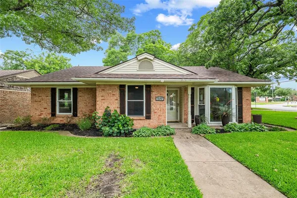 a front view of a house with a yard and porch