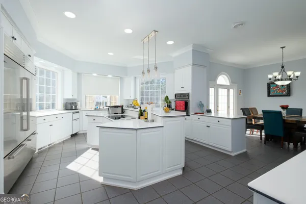 a living room with furniture a flat screen tv and a window