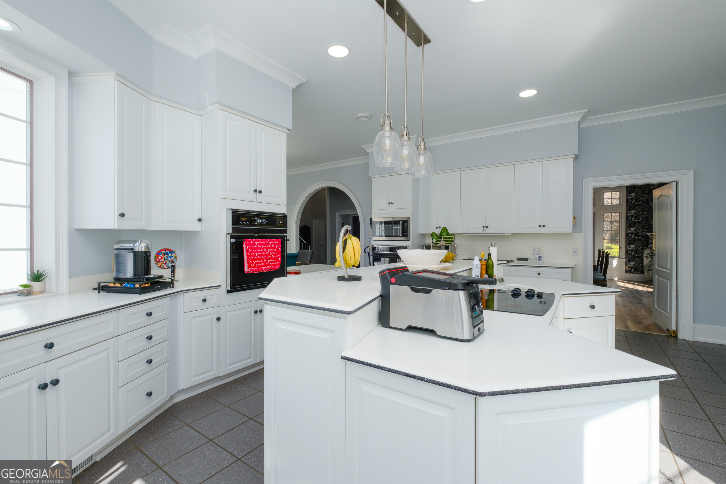 1900 Country Club Road Statesboro, GA 30458 - Photo 13 of 80 a kitchen with a sink dishwasher and white cabinets with wooden floor