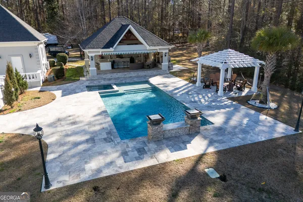 a bathroom with a granite countertop sink a toilet a mirror and a window