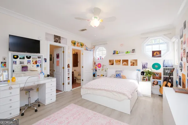 a view of a white house with a yard and large windows