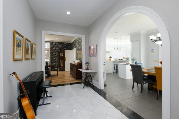 a kitchen with a sink dishwasher and white cabinets with wooden floor