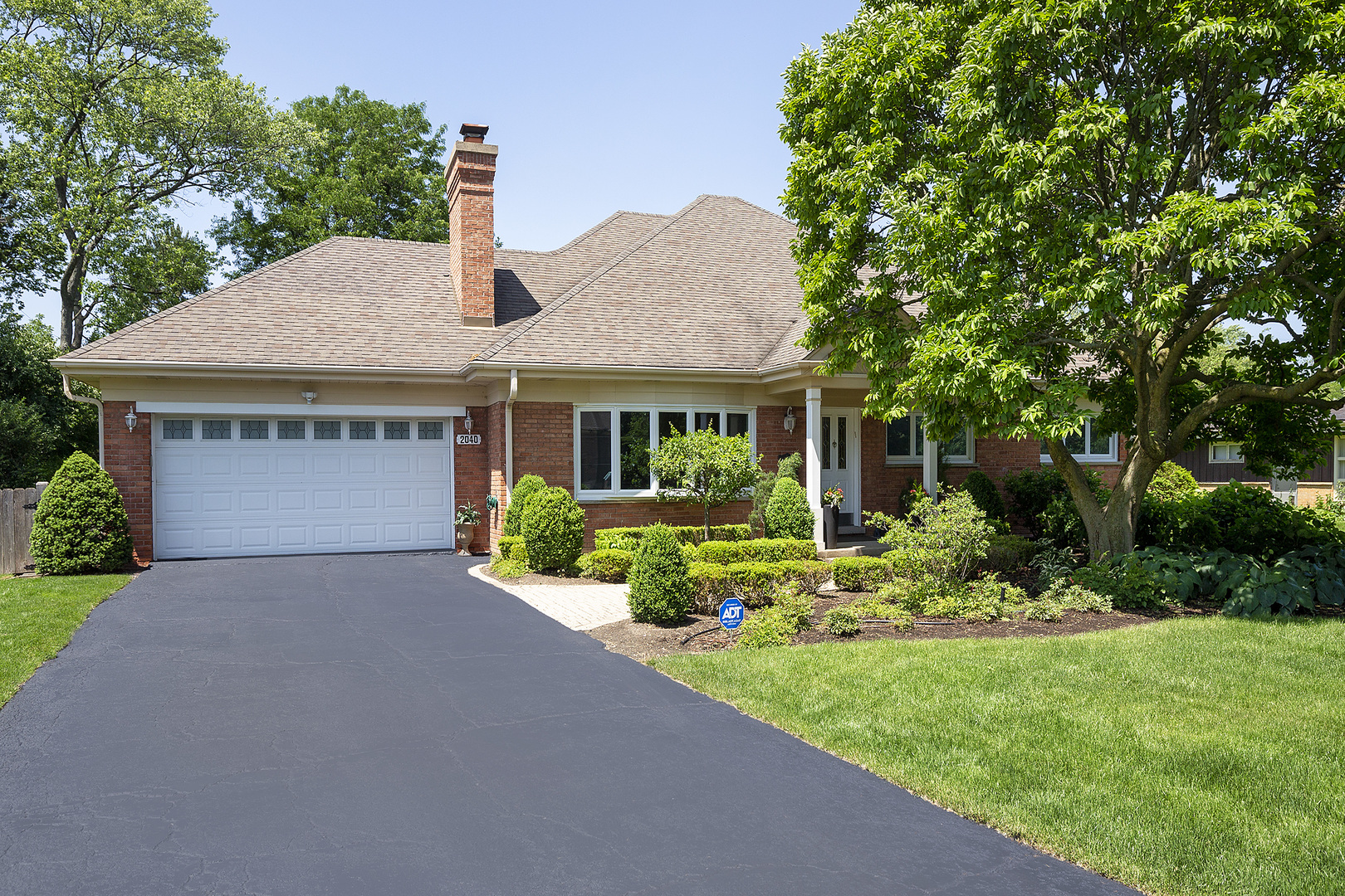 2040 Maplewood Road Northbrook, IL 60062 - Photo 2 of 30 a front view of a house with a yard and porch