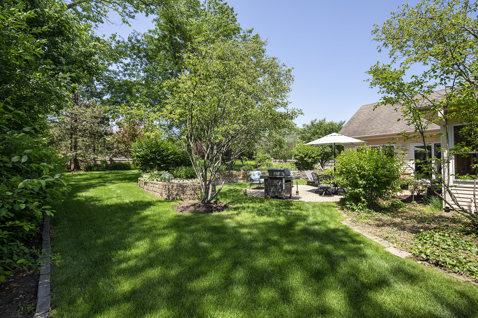 2040 Maplewood Road Northbrook, IL 60062 - Photo 24 of 30 a view of backyard with a garden and trees