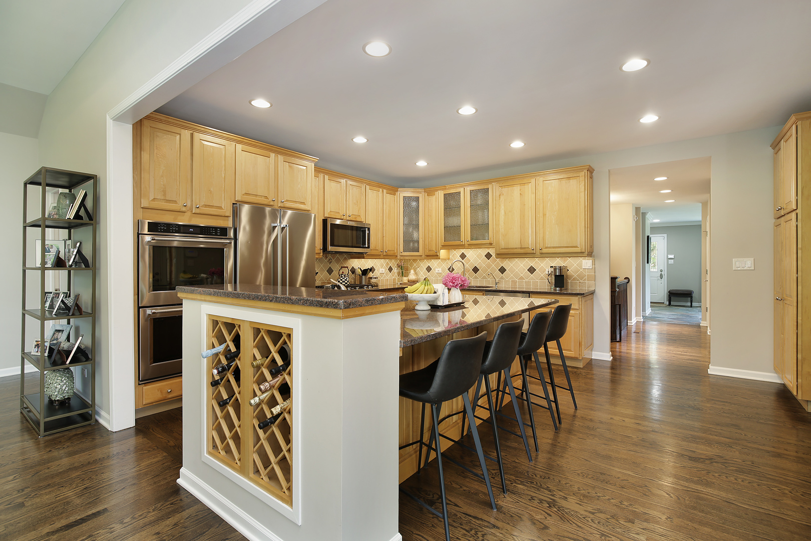 2040 Maplewood Road Northbrook, IL 60062 - Photo 7 of 30 a kitchen with stainless steel appliances a dining table chairs refrigerator and cabinets