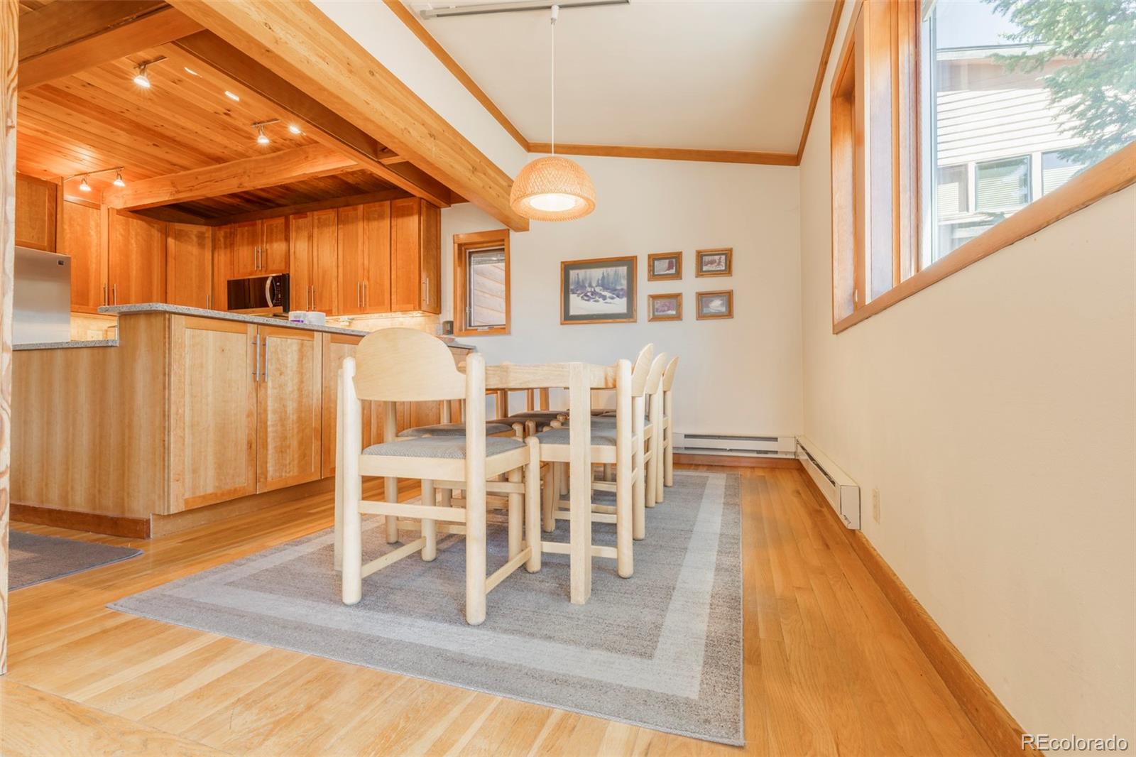 350 Tennis Club Road, Unit 1311 Dillon, CO 80435 - Photo 12 of 45 a dining room with wooden floor table and chairs