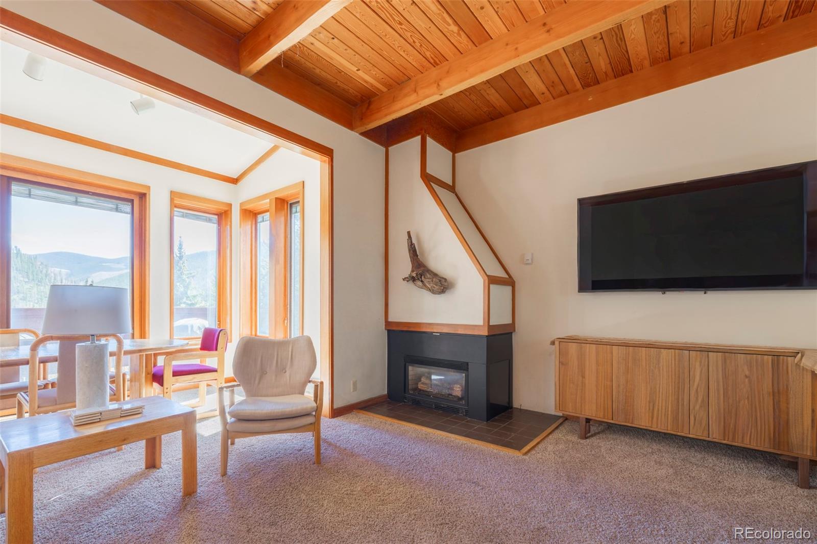 350 Tennis Club Road, Unit 1311 Dillon, CO 80435 - Photo 20 of 45 a living room with furniture a flat screen tv and a fireplace