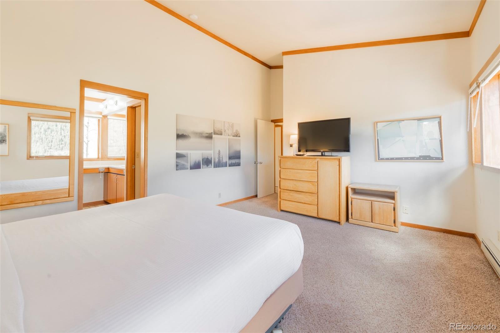 350 Tennis Club Road, Unit 1311 Dillon, CO 80435 - Photo 25 of 45 a bedroom with a bed and a flat screen tv