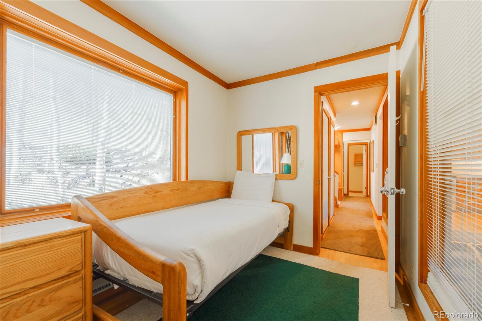 350 Tennis Club Road, Unit 1311 Dillon, CO 80435 - Photo 34 of 45 a bedroom with a bed and a dresser next to a window