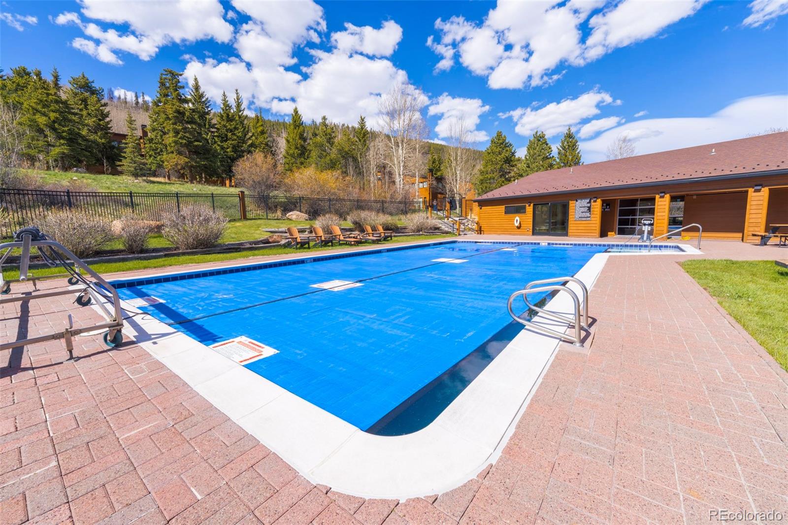 350 Tennis Club Road, Unit 1311 Dillon, CO 80435 - Photo 41 of 45 a view of swimming pool in front of residential houses with outdoor seating