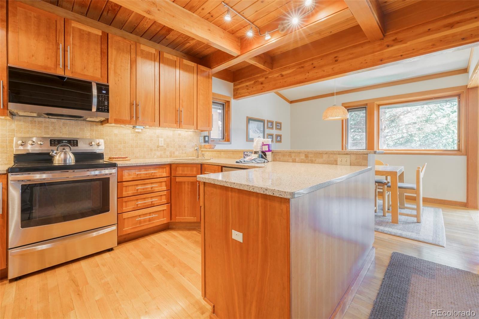 350 Tennis Club Road, Unit 1311 Dillon, CO 80435 - Photo 9 of 45 a kitchen with stainless steel appliances granite countertop a stove a sink and a microwave