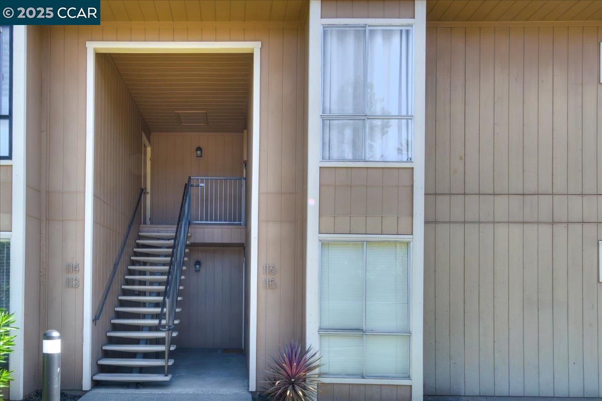8975 Alcosta Boulevard, Unit 116 San Ramon, CA 94583 - Photo 18 of 31 a view of a hallway with stairs and wooden floor