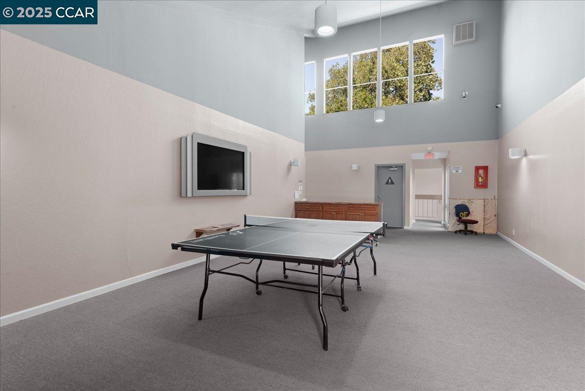 8975 Alcosta Boulevard, Unit 116 San Ramon, CA 94583 - Photo 24 of 31 a room with furniture and a flat screen tv