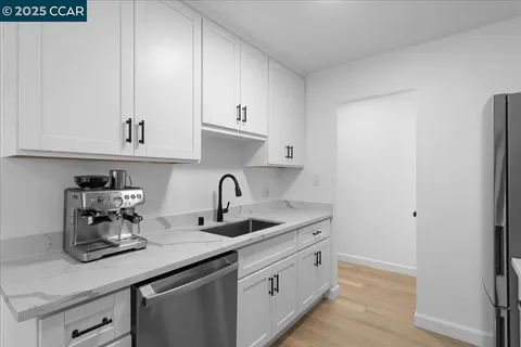 a kitchen with sink and cabinets
