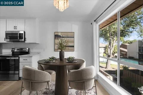 a kitchen with stainless steel appliances kitchen island granite countertop a sink and a stove