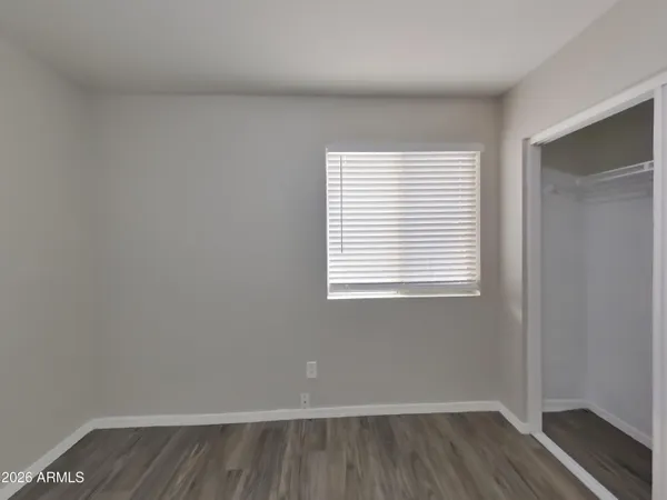 a view of a room with wooden floor