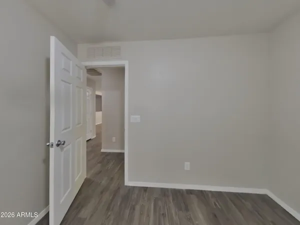 a view of a small space with wooden floor and a window