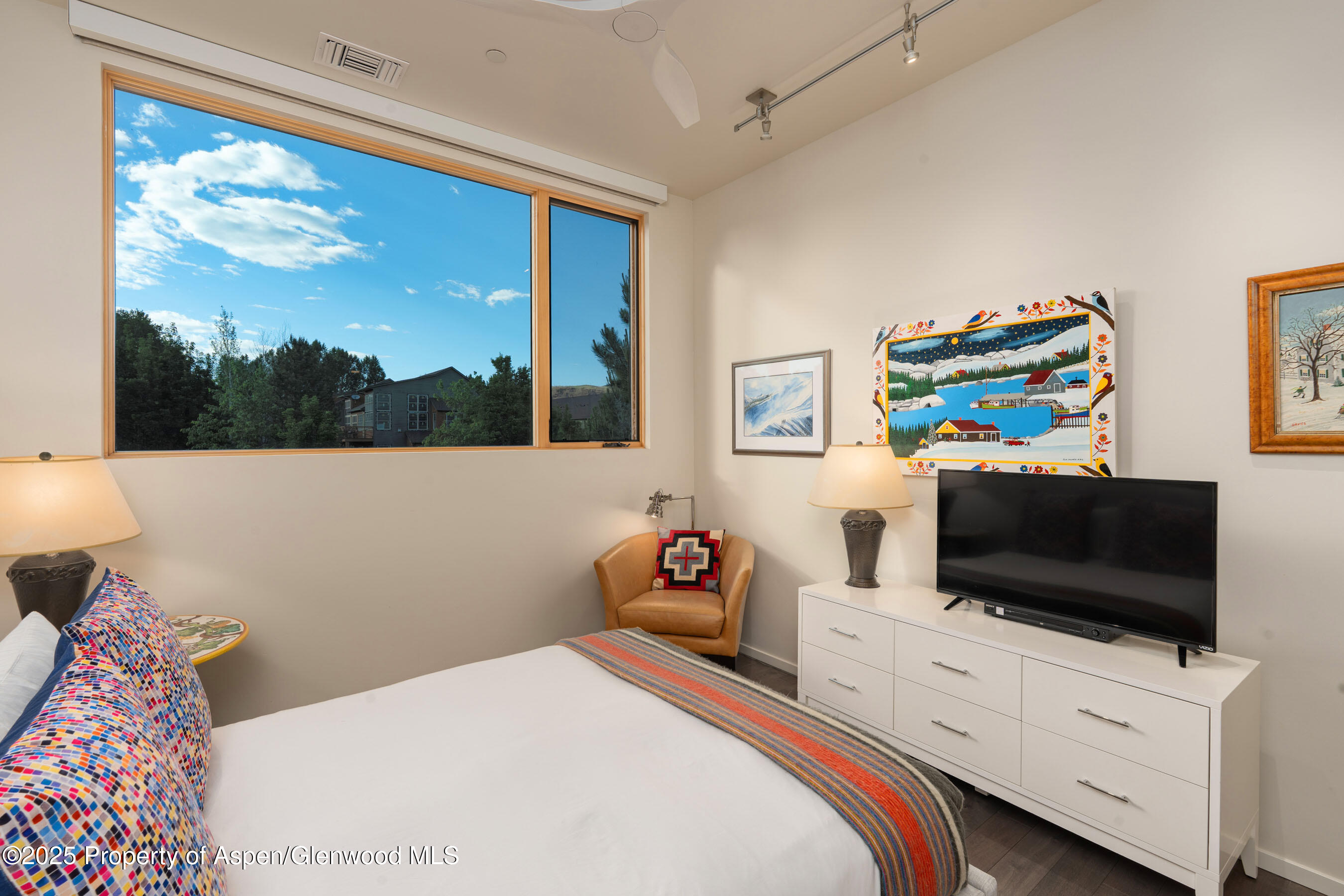 102 Evans Road, Unit 104 Basalt, CO 81621 - Photo 26 of 44 a bedroom with a bed and a flat screen tv