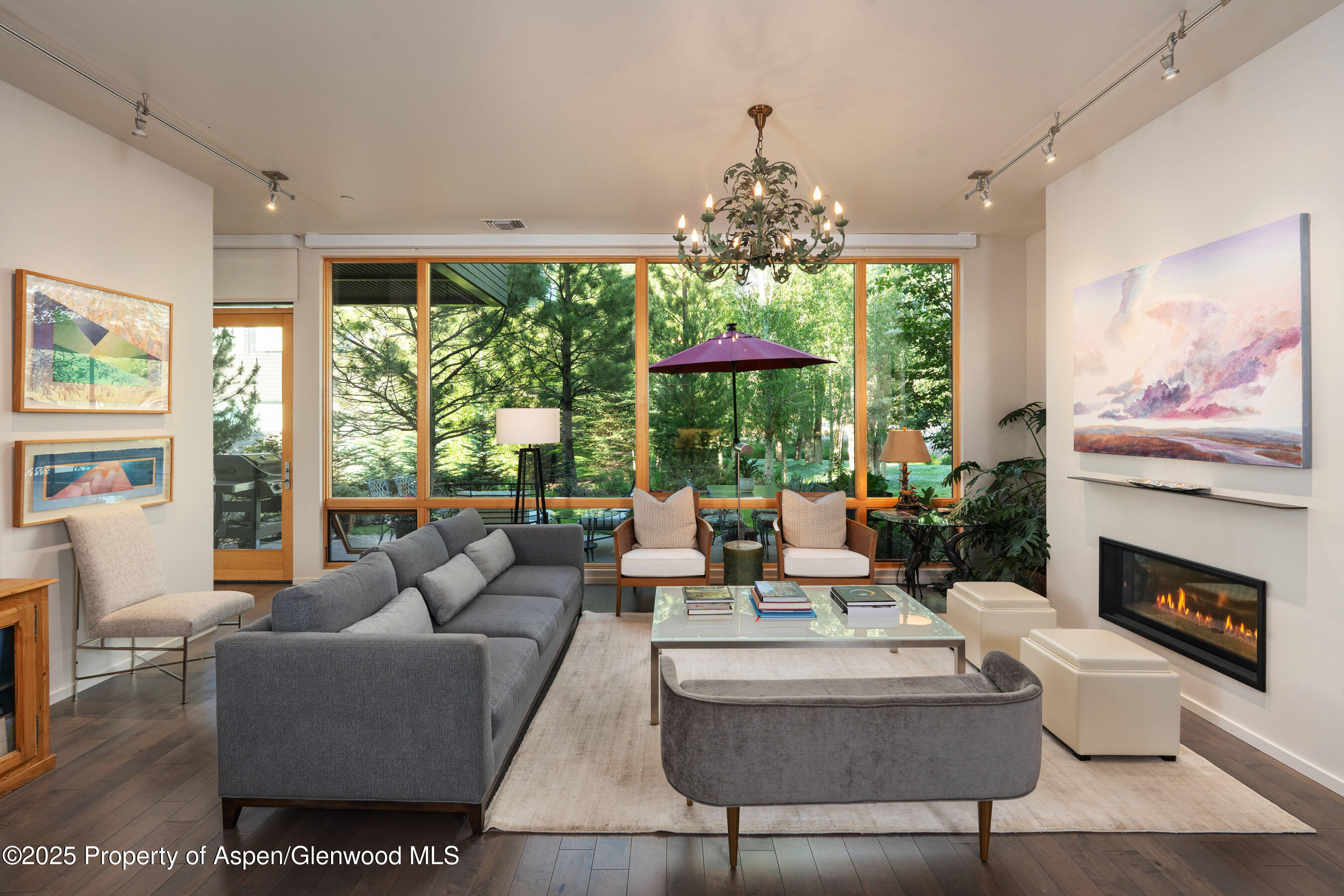102 Evans Road, Unit 104 Basalt, CO 81621 - Photo 9 of 44 a living room with furniture a chandelier and a fireplace