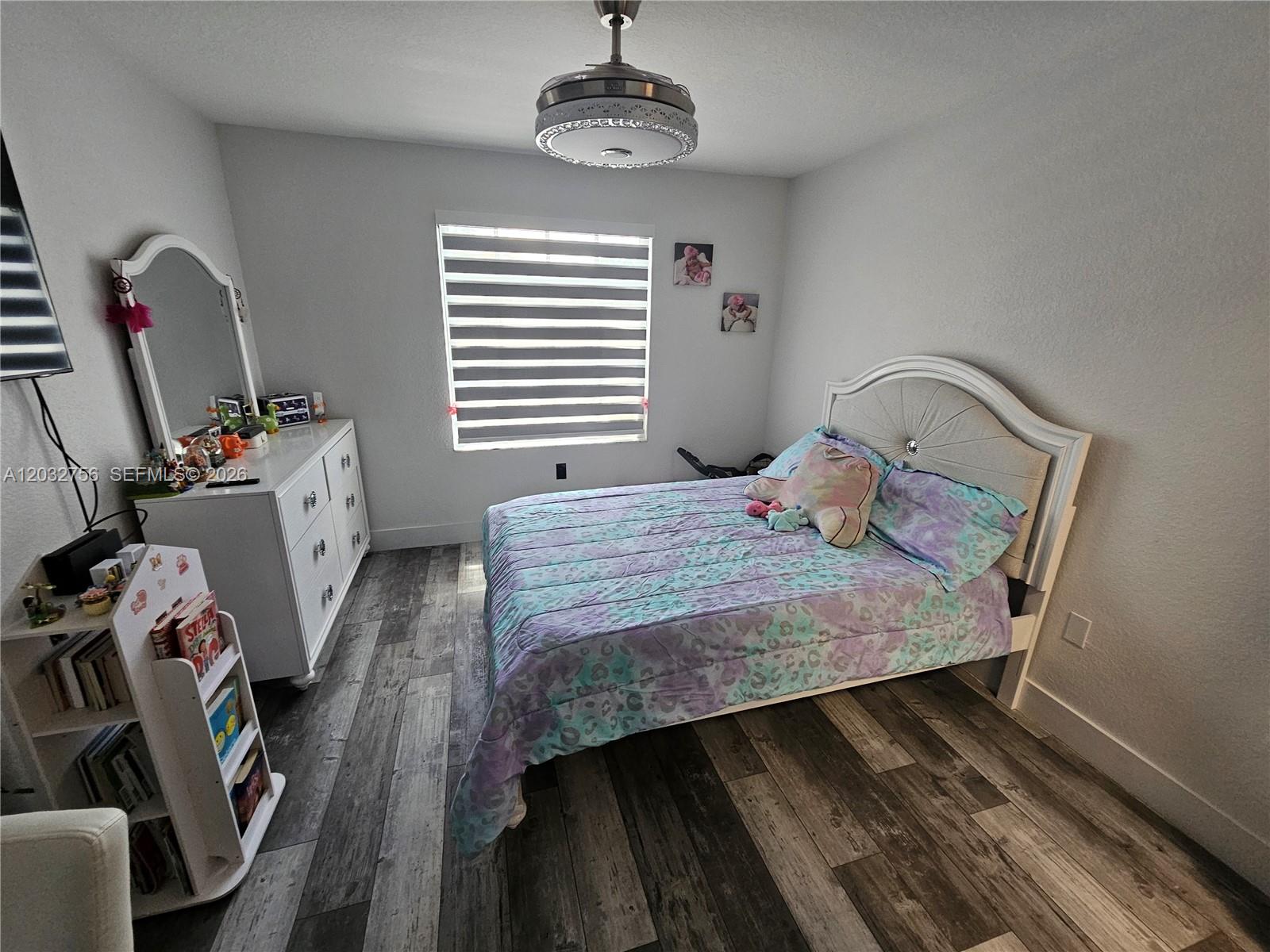 4331 Southwest 124th Way Miramar, FL 33027 - Photo 18 of 40 a bedroom with a bed a window and dresser