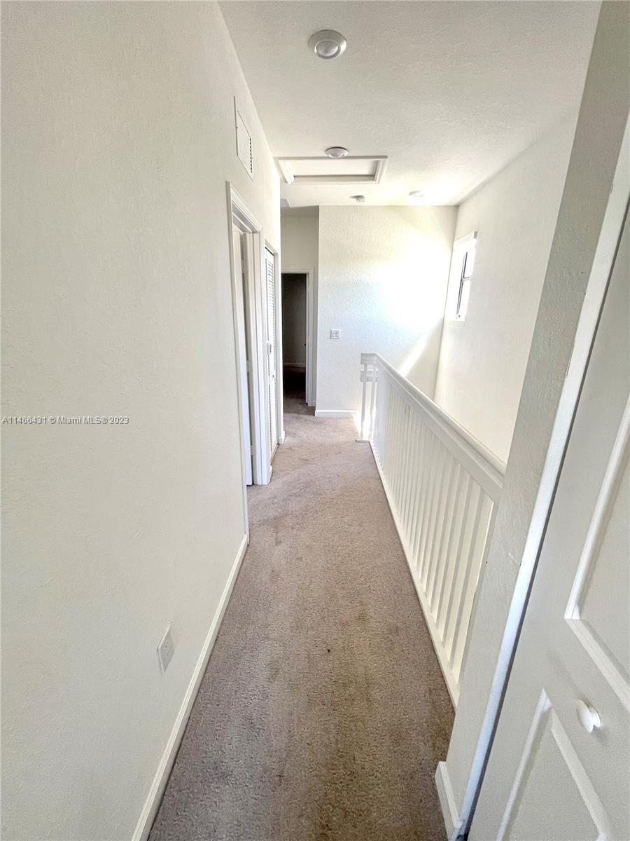 23373 Southwest 129th Path, Unit 23373 Miami, FL 33186 - Photo 16 of 20 a view of a hallway with staircase