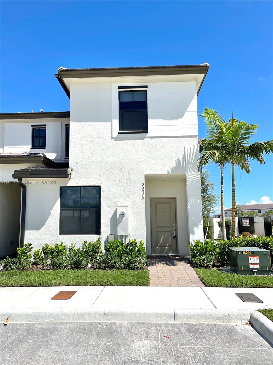 23373 Southwest 129th Path, Unit 23373 Miami, FL 33186 - Photo 20 of 20 a front view of a house with garden