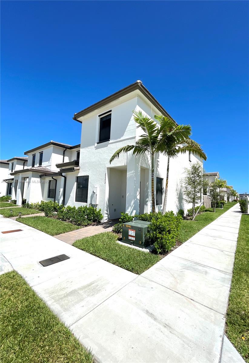 23373 Southwest 129th Path, Unit 23373 Miami, FL 33186 - Photo 2 of 20 a view of a white house with a yard