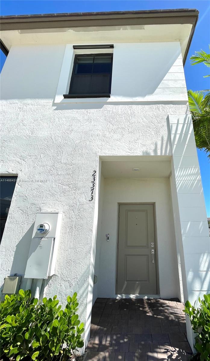 23373 Southwest 129th Path, Unit 23373 Miami, FL 33186 - Photo 4 of 20 a front view of a house with a yard