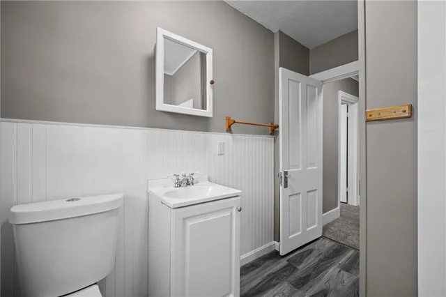 a bathroom with a toilet sink and a mirror