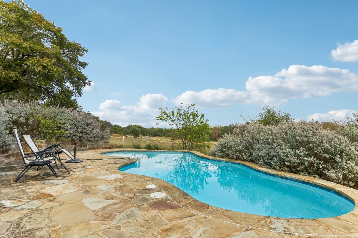 24369-2 Bingham Creek Road, Unit 12 Leander, TX 78641 - Photo 1 of 22 a view of a swimming pool with a yard