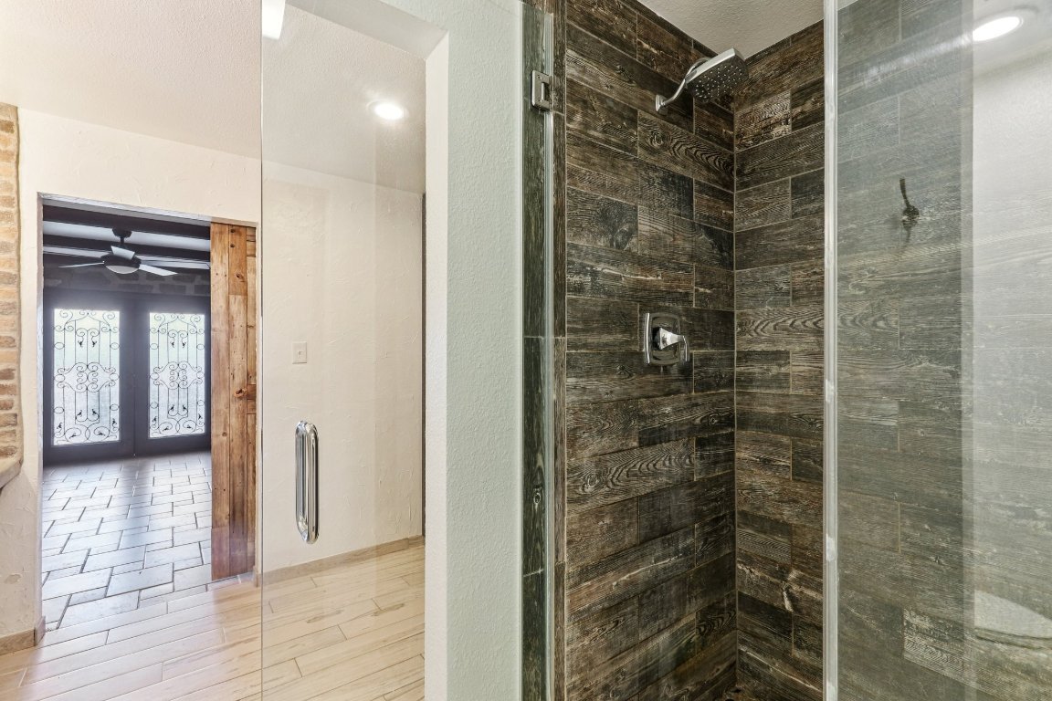 24369-2 Bingham Creek Road, Unit 12 Leander, TX 78641 - Photo 11 of 22 a bathroom with a shower and a glass door