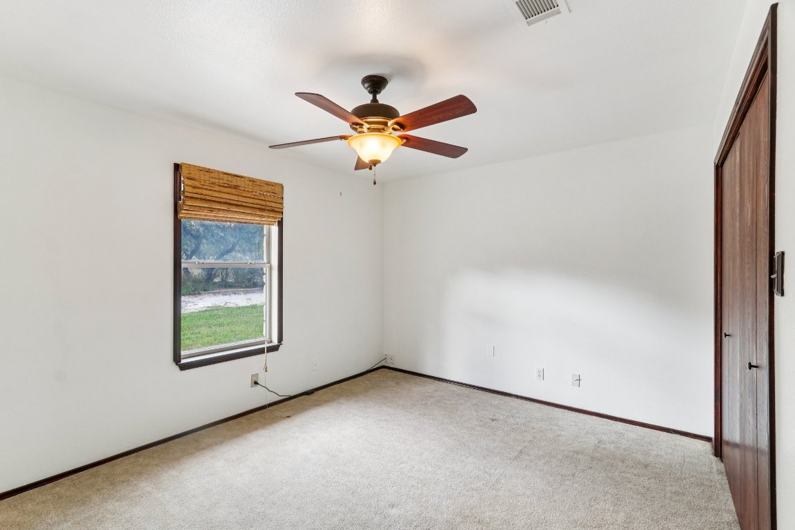 24369-2 Bingham Creek Road, Unit 12 Leander, TX 78641 - Photo 18 of 22 an empty room with windows and fan