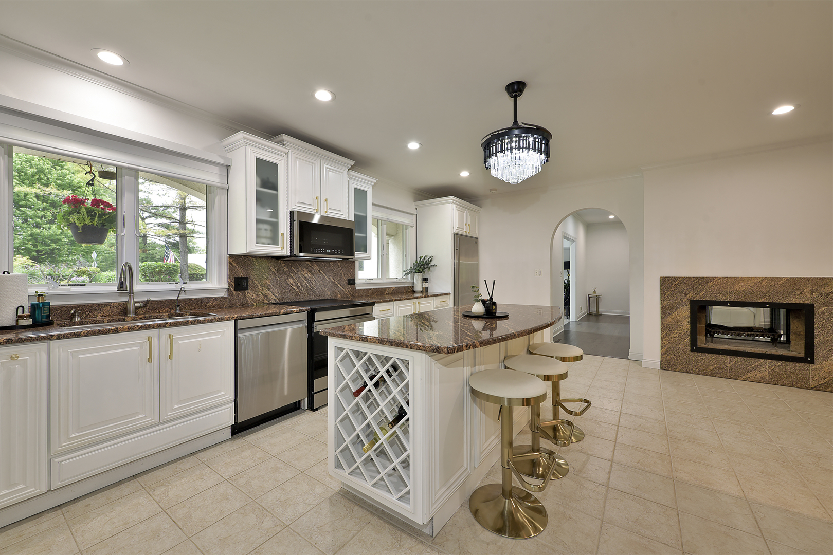 144 North Highland Road Inverness, IL 60067 - Photo 10 of 49 a kitchen with stainless steel appliances granite countertop a sink a stove a microwave a counter top cabinets and a window