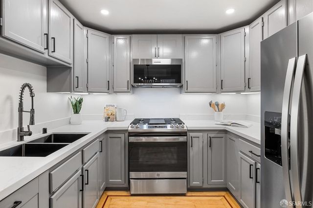a kitchen with cabinets appliances and a sink