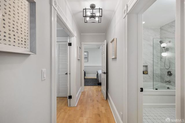 a bedroom with a bed couch and painting on the wall