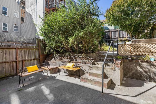 a view of a patio with couches table and chairs and potted plants