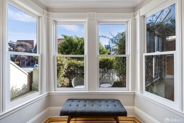 a living room with furniture a fireplace and a chandelier