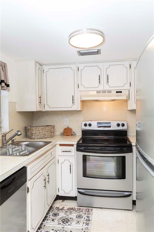 4609 Marine Parkway, Unit 203 New Port Richey, FL 34652 - Photo 12 of 25 a kitchen with cabinets and appliances