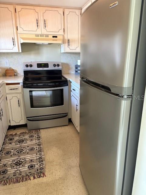 4609 Marine Parkway, Unit 203 New Port Richey, FL 34652 - Photo 13 of 25 a kitchen with white cabinets and white appliances