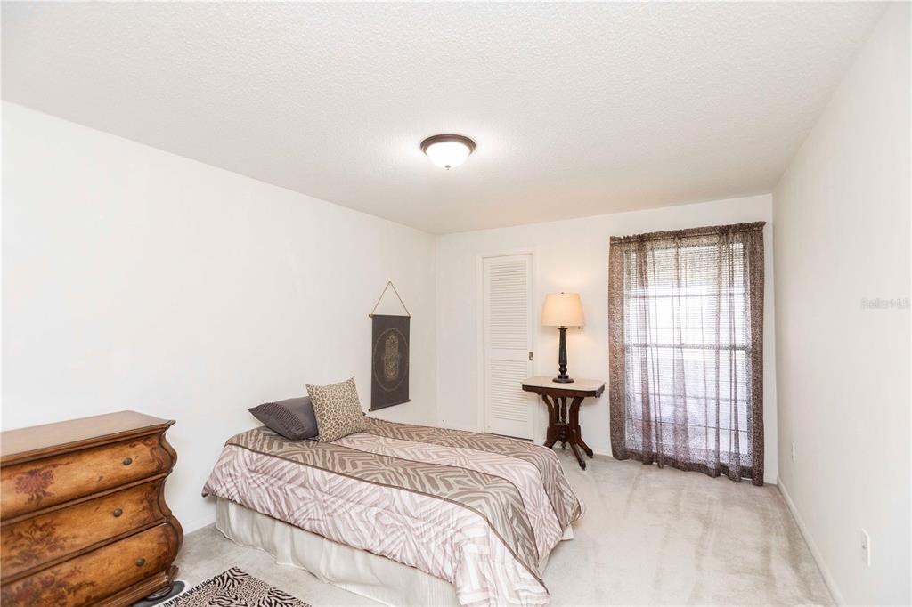 4609 Marine Parkway, Unit 203 New Port Richey, FL 34652 - Photo 15 of 25 a bedroom with a bed and a window