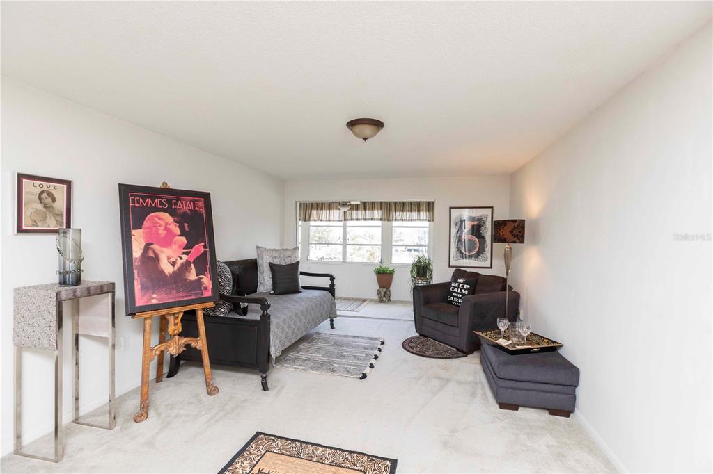 4609 Marine Parkway, Unit 203 New Port Richey, FL 34652 - Photo 6 of 25 a living room with furniture and a window