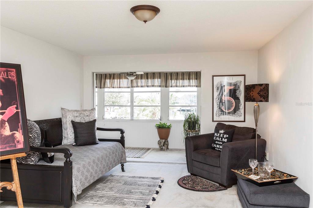 4609 Marine Parkway, Unit 203 New Port Richey, FL 34652 - Photo 8 of 25 a living room with furniture and a window