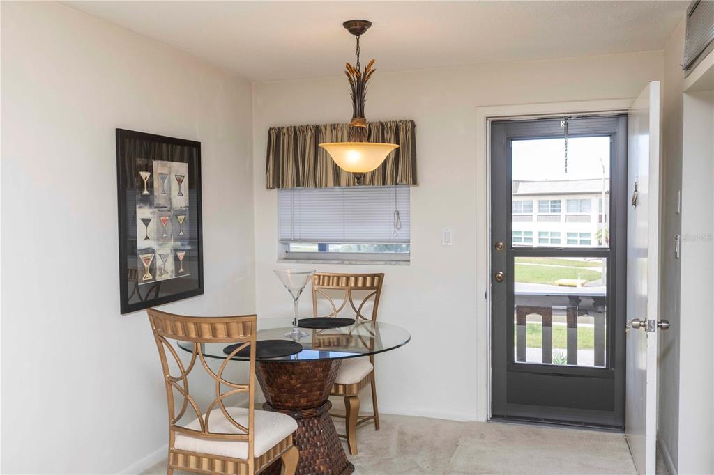 4609 Marine Parkway, Unit 203 New Port Richey, FL 34652 - Photo 9 of 25 a dining room with furniture and window