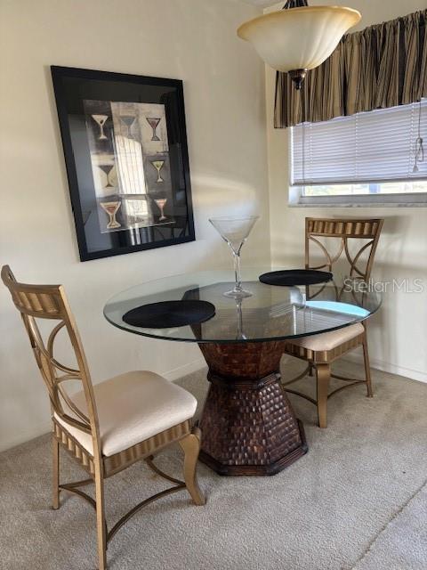 4609 Marine Parkway, Unit 203 New Port Richey, FL 34652 - Photo 10 of 25 a living room with a table and chairs