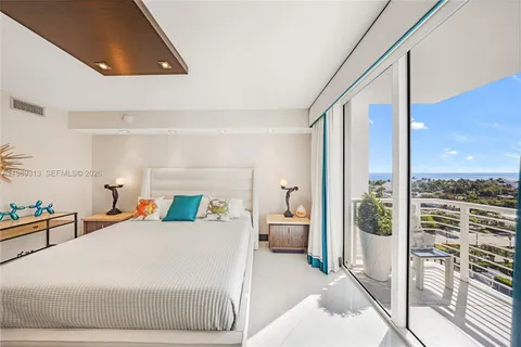 a bedroom with a large bed and a large window