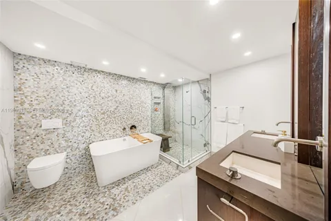 a bathroom with a sink toilet and shower