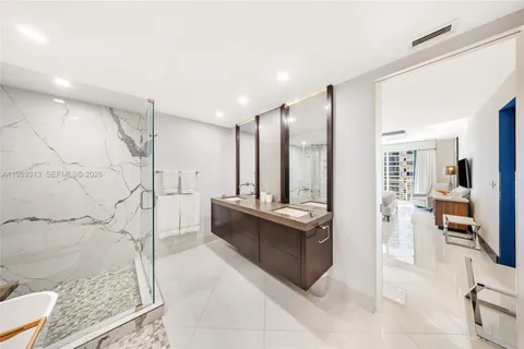 a large bathroom with a glass shower door