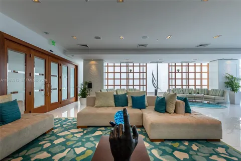 a view of a building with a yard and plants