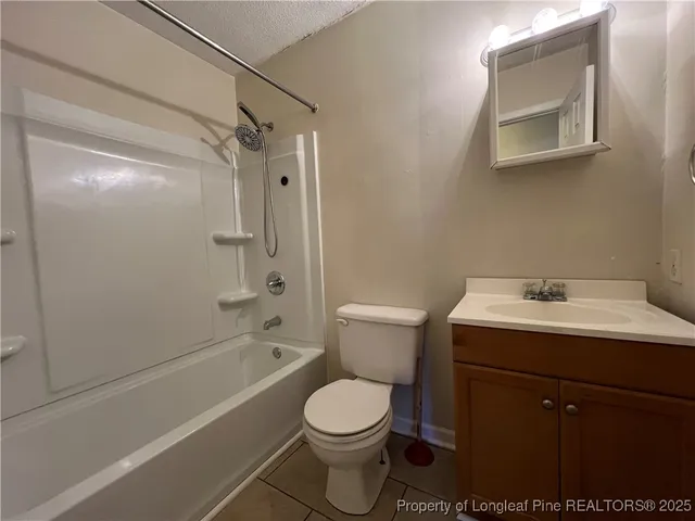 a bathroom with a toilet sink shower and mirror